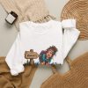 White hiking sweatshirt folded flat, design on the front