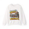 White crewneck sweatshirt printed on the front with a horrified construction worker in a hard hat and hi-vis vest kneeling on a fresh concrete slab, with orange conduit visible buried in the gravel below and the words "We Poured the Concrete. Then Found the Missing Conduit."