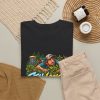 Black T-shirt with "Still Looking for My Disc" disc golf graphic, lifestyle flat-lay