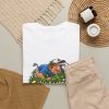 White T-shirt with "Still Looking for That Fairway" golf graphic, lifestyle flat-lay
