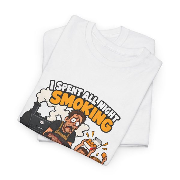 Folded white T-shirt showing "I Spent All Night Smoking... The Kids Asked for Nuggets" BBQ dad graphic