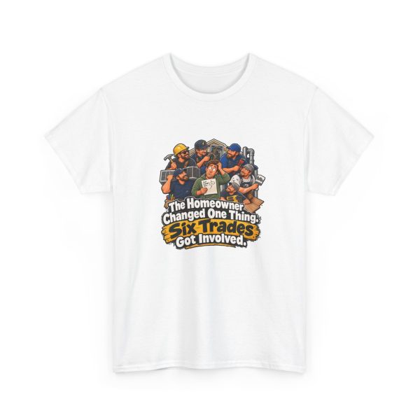 White t-shirt printed on the front with a bewildered homeowner in a green hoodie holding a small change sketch while six grinning tradesmen with tools crowd around him and the words "The Homeowner Changed One Thing. Six Trades Got Involved."