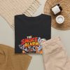 Black T-shirt with "The Smoke Alarm Is Just Applause" BBQ graphic, lifestyle flat-lay