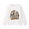 White crewneck sweatshirt printed on the front with two grinning drywallers in sunglasses and suspenders hanging a drywall sheet while a cartoon skeleton peeks out of the open stud bay and the words "The Drywall Crew Covered It. Whatever It Was."
