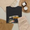 Black T-shirt with "The Cast Was Perfect. The Fish Disagreed." fishing graphic, lifestyle flat-lay