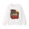 White crewneck sweatshirt printed with "I Track. I Wait. I Miss." and a hunter in a wooden blind