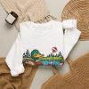 Close-up of the crewneck print showing the mallard, a golf flag in a Santa hat and the "I Got Golf Balls For Christmas. The Lake Says Thanks." lettering