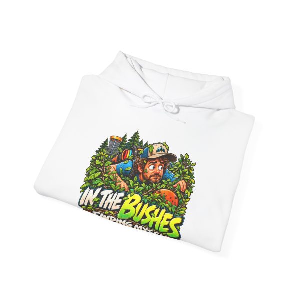 Folded white hoodie showing "In the Bushes Finding Myself" disc golf graphic