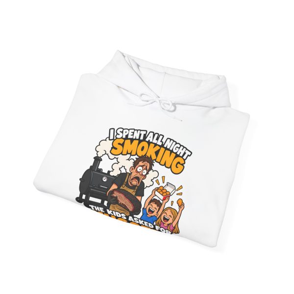 Folded white hoodie showing "I Spent All Night Smoking... The Kids Asked for Nuggets" BBQ dad graphic