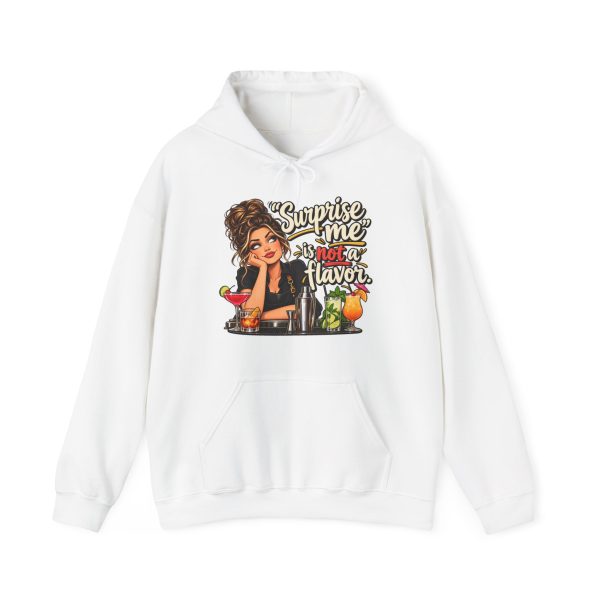 Front of the white unisex hoodie printed with an eye-rolling bartender in a black apron leaning on the bar behind a row of cocktails and a steel shaker and the words “Surprise me” is not a flavor.