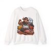White sweatshirt printed with "I RUB. I SMOKE. I REST." and a bull in a cap and sunglasses sprinkling dry rub by hand