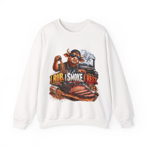 White sweatshirt printed with "I RUB. I SMOKE. I REST." and a bull in a cap and sunglasses sprinkling dry rub by hand