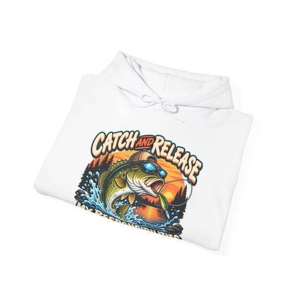 Folded white hoodie showing "Catch and Release My Responsibilities" fishing graphic