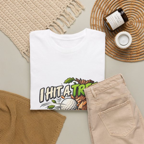 White T-shirt with "I Hit a Tree and Called It Strategy" golf graphic, lifestyle flat-lay