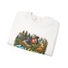 Folded white crewneck sweatshirt showing "Still Looking for My Disc" disc golf graphic