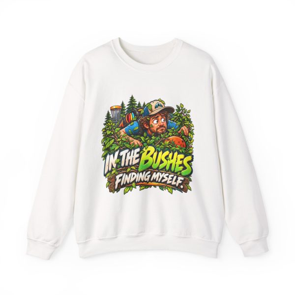 White disc golf crewneck sweatshirt printed with IN THE BUSHES FINDING MYSELF and a disc golfer in a cap peering out of dense green bushes with leaves