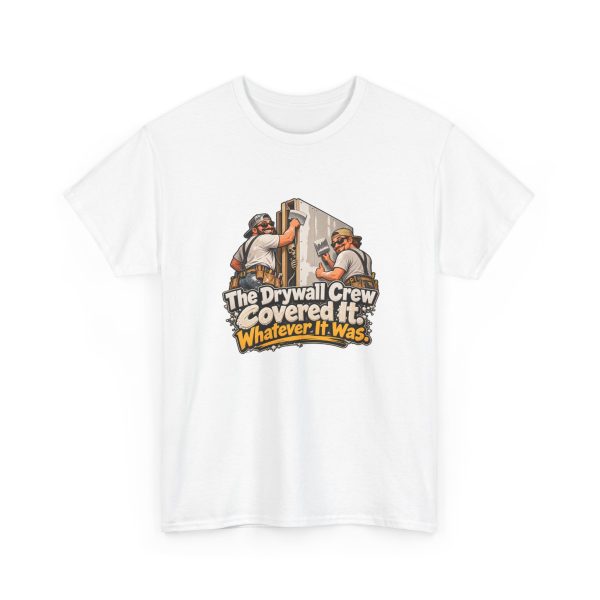 White t-shirt printed on the front with two grinning drywallers in sunglasses and suspenders hanging a drywall sheet while a cartoon skeleton peeks out of the open stud bay and the words "The Drywall Crew Covered It. Whatever It Was."