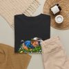 Black T-shirt with "Still Looking for That Fairway" golf graphic, lifestyle flat-lay