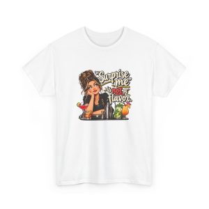 Front of the white unisex t-shirt printed with an eye-rolling bartender in a black apron leaning on the bar behind a row of cocktails and a steel shaker and the words “Surprise me” is not a flavor.