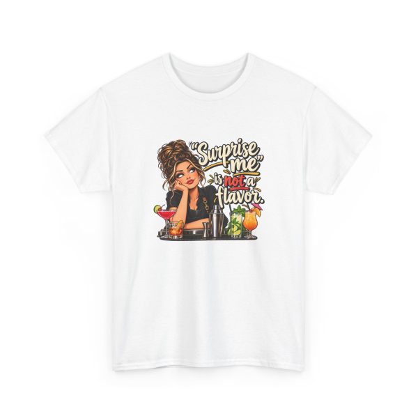 Front of the white unisex t-shirt printed with an eye-rolling bartender in a black apron leaning on the bar behind a row of cocktails and a steel shaker and the words “Surprise me” is not a flavor.