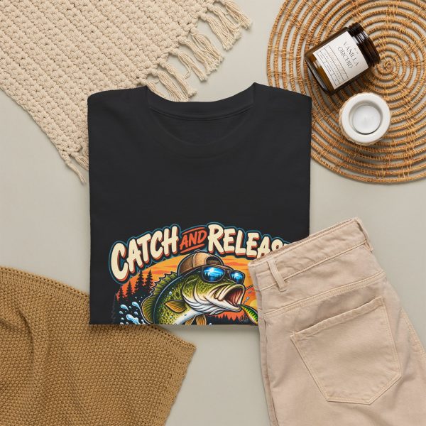 Black T-shirt with "Catch and Release My Responsibilities" fishing graphic, lifestyle flat-lay