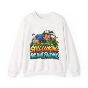White sweatshirt printed with "STILL LOOKING FOR THAT FAIRWAY." and a squinting golfer in a blue polo and white cap
