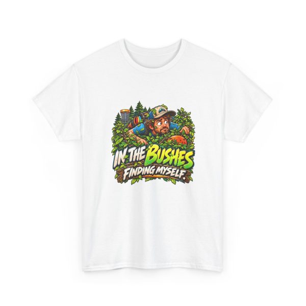 White disc golf T-shirt printed with IN THE BUSHES FINDING MYSELF and a disc golfer in a cap peering out of dense green bushes with leaves in his hair