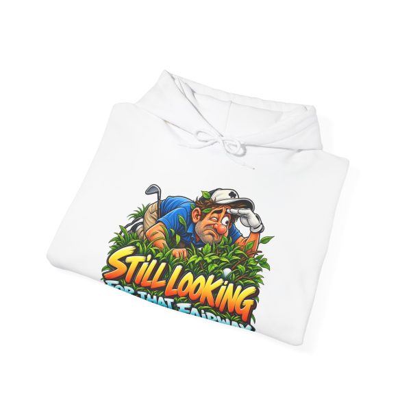 Folded white hoodie showing "Still Looking for That Fairway" golf graphic