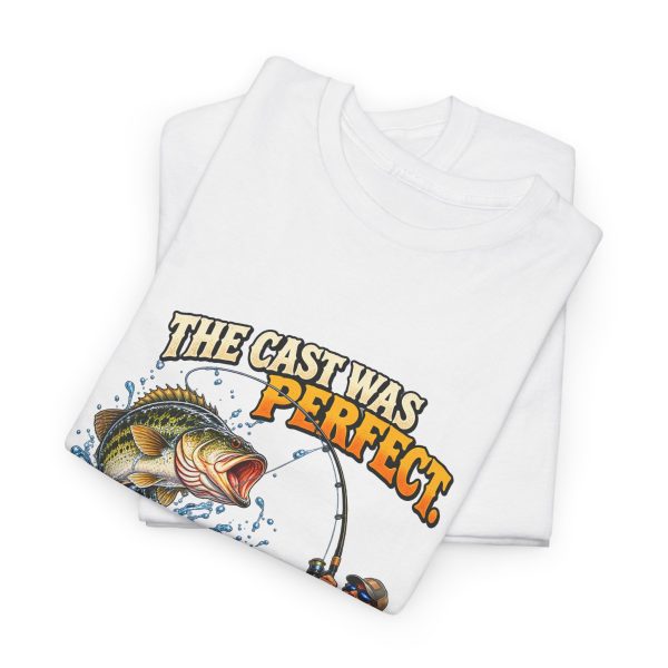 Folded white T-shirt showing "The Cast Was Perfect. The Fish Disagreed." fishing graphic