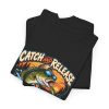 Folded black T-shirt showing "Catch and Release My Responsibilities" fishing graphic
