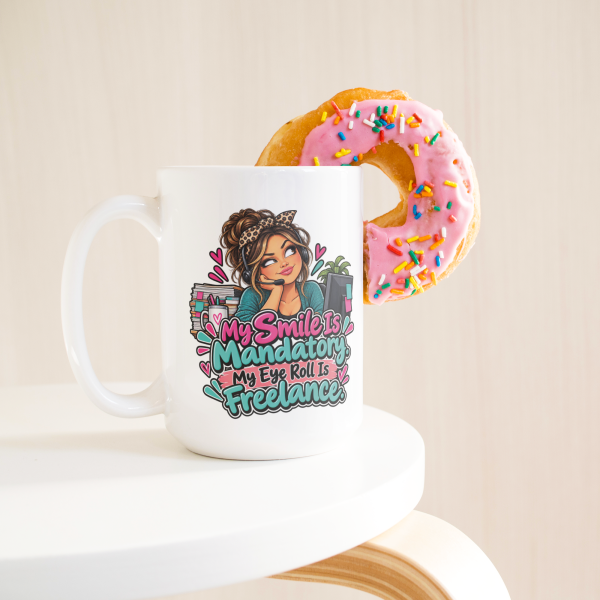 My Smile Is Mandatory. My Eye Roll Is Freelance. funny 15oz white coffee mug, on a table with a donut
