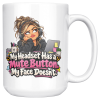 White coffee mug printed on both sides with a side-eyeing support agent in a black hoodie and headset resting her chin on her hand at a desk with a laptop covered in sticky notes, a mug of pens and a small succulent and the words "My Headset Has a Mute Button. My Face Doesn't."