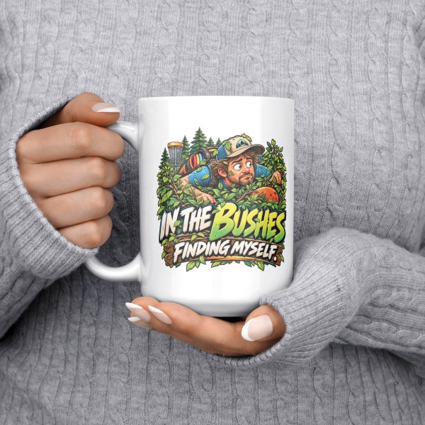 In the Bushes Finding Myself funny 15oz white mug, held at chest