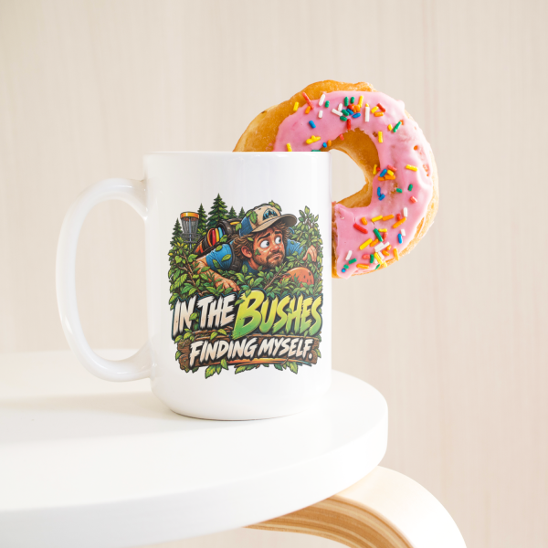 In the Bushes Finding Myself funny 15oz white mug, with a donut on the rim, left handle