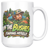 15oz white ceramic disc golf mug printed with IN THE BUSHES FINDING MYSELF and a disc golfer in a cap peering out of dense green bushes with leaves
