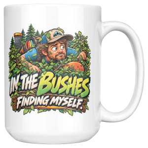 15oz white ceramic disc golf mug printed with IN THE BUSHES FINDING MYSELF and a disc golfer in a cap peering out of dense green bushes with leaves