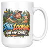 Still Looking for My Disc 15oz mug - right handle 15oz white ceramic disc golf mug printed with STILL LOOKING FOR MY DISC and a wide-eyed disc golfer crawling through thick brush and branches