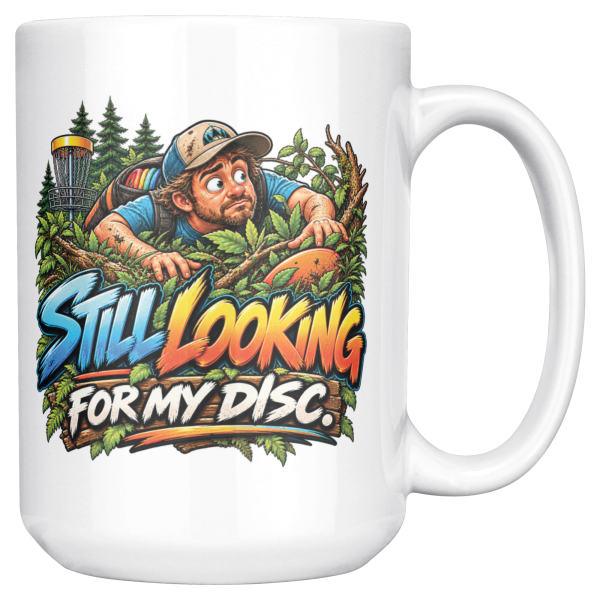 Still Looking for My Disc 15oz mug - right handle 15oz white ceramic disc golf mug printed with STILL LOOKING FOR MY DISC and a wide-eyed disc golfer crawling through thick brush and branches