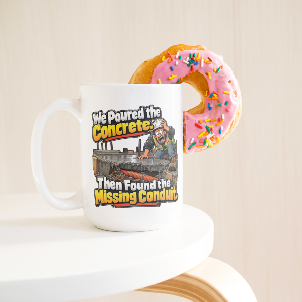 We Poured the Concrete. Then Found the Missing Conduit. funny 15oz white coffee mug, on a table with a donut