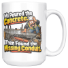 White coffee mug printed on both sides with a horrified construction worker in a hard hat and hi-vis vest kneeling on a fresh concrete slab, with orange conduit visible buried in the gravel below and the words "We Poured the Concrete. Then Found the Missing Conduit."