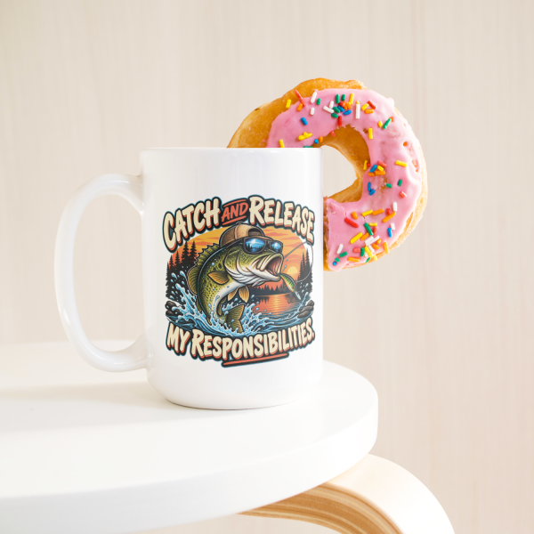 Funny_Fishing_Mug_Catch_and_Release_My__15ozWhiteMugLifetsyleDonutLH_Mockup-thumb.750x750.png Catch and Release My Responsibilities funny 15oz white mug, with a donut on the rim, left handle