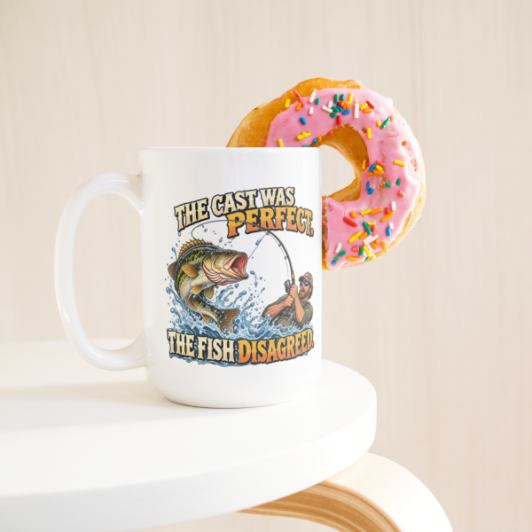 The Cast Was Perfect. The Fish Disagreed. funny 15oz white mug, with a donut on the rim, left handle
