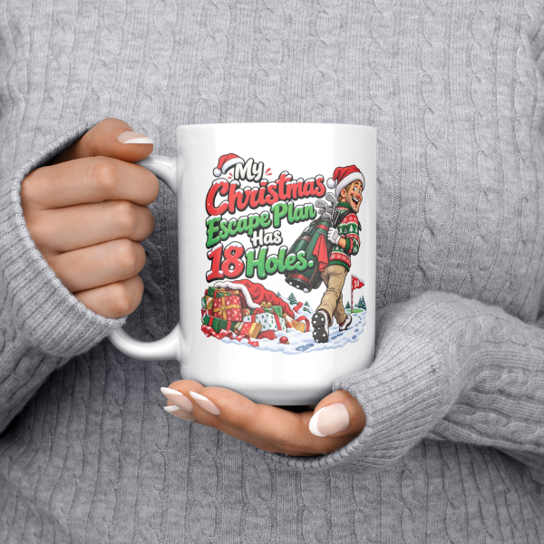 15oz white ceramic golf Christmas mug with a golfer in a Santa hat tiptoeing away from presents with his golf bag and the words My Christmas Escape Plan Has 18 Holes.