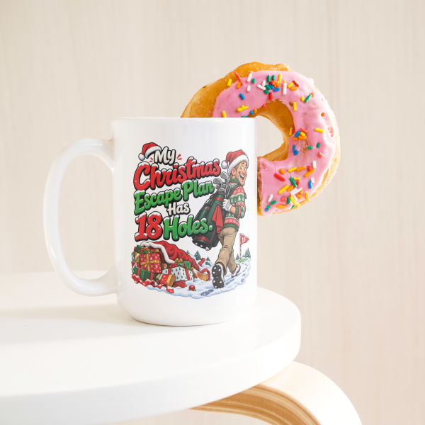 15oz white ceramic golf Christmas mug with a golfer in a Santa hat tiptoeing away from presents with his golf bag and the words My Christmas Escape Plan Has 18 Holes.