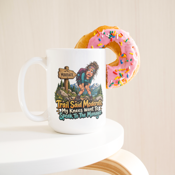 Trail Said Moderate. My Knees Want To Speak To The Manager. funny 15oz white coffee mug, on a table with a donut