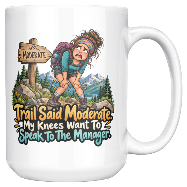 White 15oz ceramic mug with the handle on the right, showing a worn-out hiker clutching her knees beside a wooden MODERATE trail sign, with pine trees and snowy mountains and the words "Trail Said Moderate. My Knees Want To Speak To The Manager."