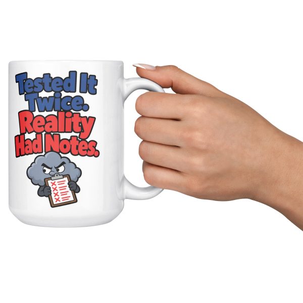 15 oz white ceramic engineer mug printed with "Tested It Twice. Reality Had Notes.", held out by the handle