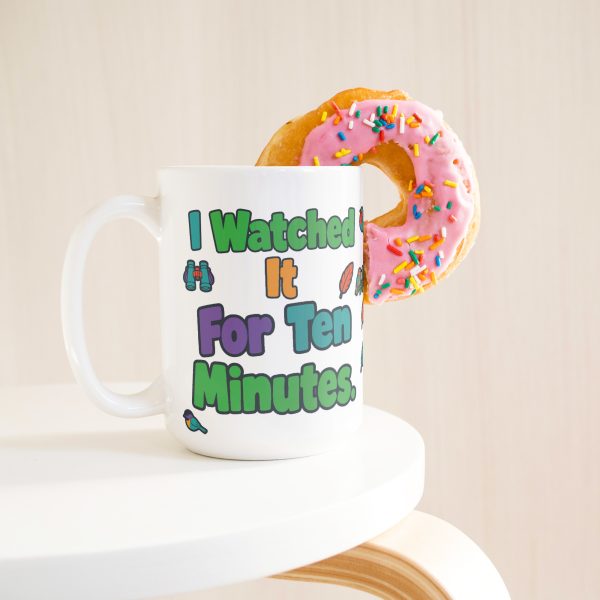 "I watched it for ten minutes. It was a leaf." Birding 15oz mug, with a donut 15 oz white ceramic birding mug, "I watched it for ten minutes" on one side and "It was a leaf" on the other, with birds, binoculars and leaves, with a donut