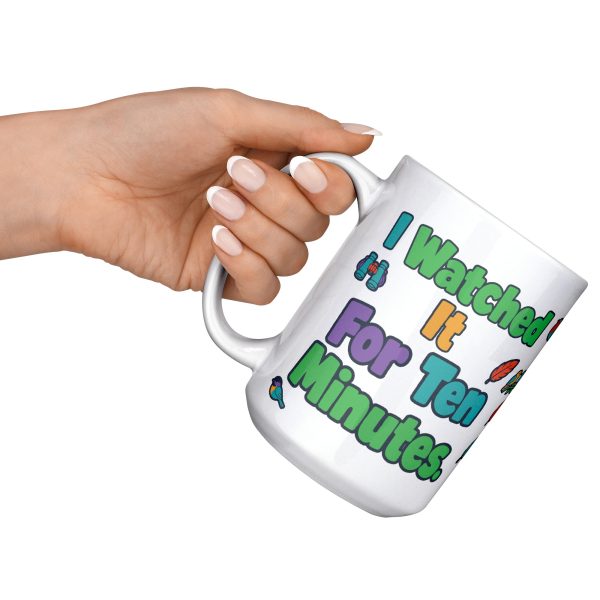"I watched it for ten minutes. It was a leaf." Birding 15oz mug, raised at an angle 15 oz white ceramic birding mug, "I watched it for ten minutes" on one side and "It was a leaf" on the other, with birds, binoculars and leaves, raised at an angle
