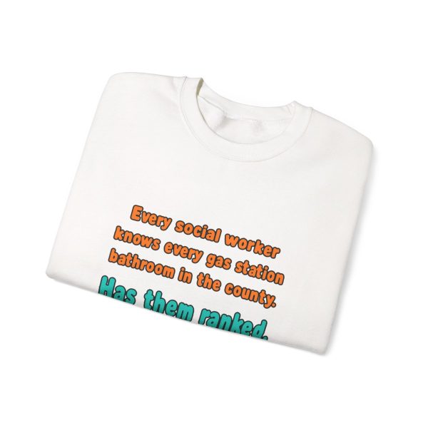 White flat vector crewneck sweatshirt with the social work dictionary joke: Knows every gas station bathroom in the county. Has them ranked., folded view